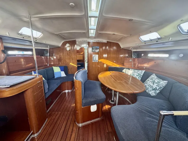  Yacht Photos Pics Interior of 1991 Beneteau 45 First yacht with cozy seating and wooden finishes.
