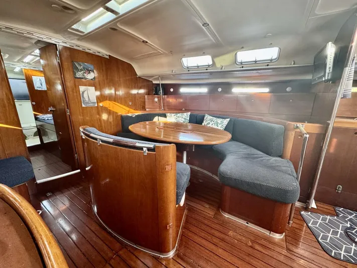  Yacht Photos Pics Interior of 1991 Beneteau 45 First yacht with wooden furnishings and cozy seating area.