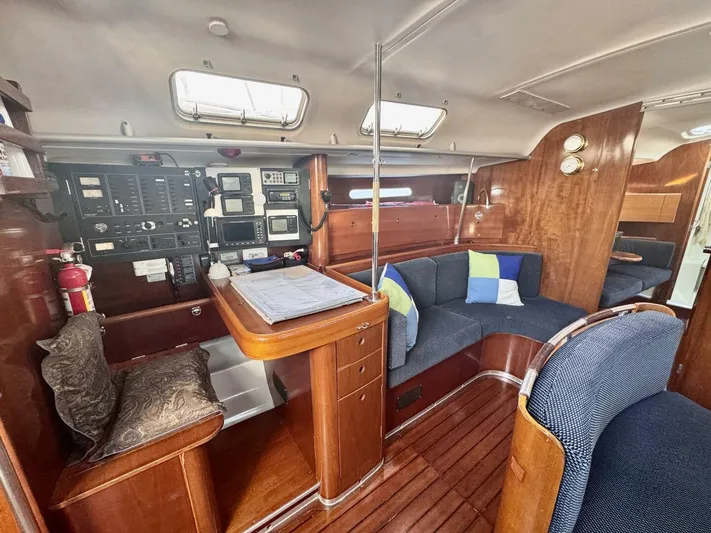  Yacht Photos Pics Interior of 1991 Beneteau 45 First yacht with navigation station and cozy seating area.
