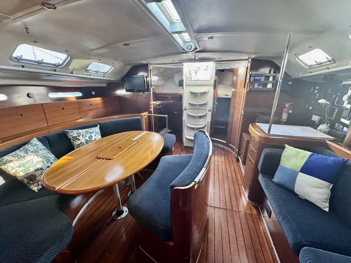  Yacht Photos Pics Interior of 1991 Beneteau 45 First yacht with wooden furnishings and cozy seating area.