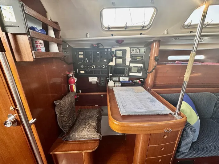  Yacht Photos Pics Interior of 1991 Beneteau 45 First sailboat with navigation station and wooden cabinetry.