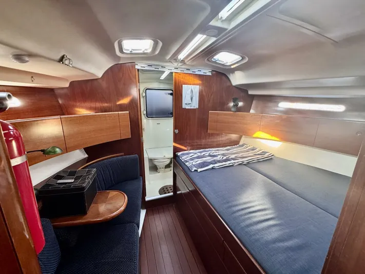  Yacht Photos Pics Interior of 1991 Beneteau 45 First yacht, featuring cozy cabin with bed and seating area.