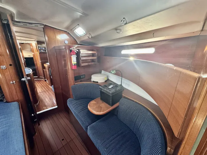  Yacht Photos Pics Interior of 1991 Beneteau 45 First yacht with wooden paneling and cozy seating area.