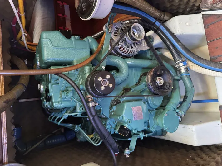  Yacht Photos Pics Engine of a 1991 Beneteau 45 First sailboat, showcasing mechanical components and hoses.