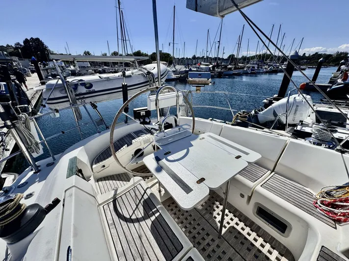  Yacht Photos Pics Cockpit of a 1991 Beneteau 45 First sailboat docked at a marina.