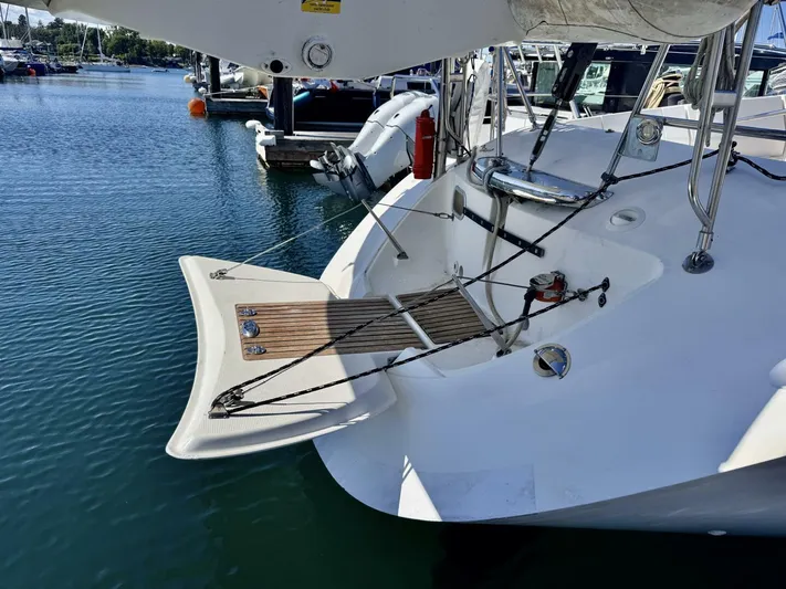  Yacht Photos Pics Beneteau 45 First 1991 yacht stern with swim platform in marina.