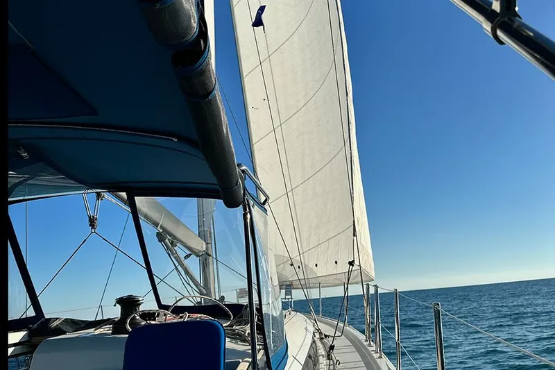 Nautical Dreamer Yacht Photos Pics 2019 Jeanneau Sun Odyssey 490 sailing on open sea under clear blue sky.