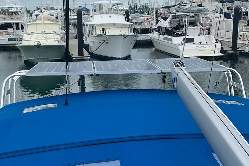 Nautical Dreamer Yacht Photos Pics 2019 Jeanneau Sun Odyssey 490 with solar panels docked at a marina.