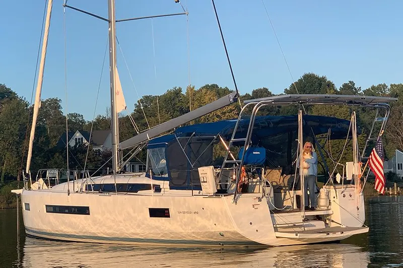 Nautical Dreamer Yacht Photos Pics 2019 Jeanneau Sun Odyssey 490 sailboat on calm water, with a person on deck.