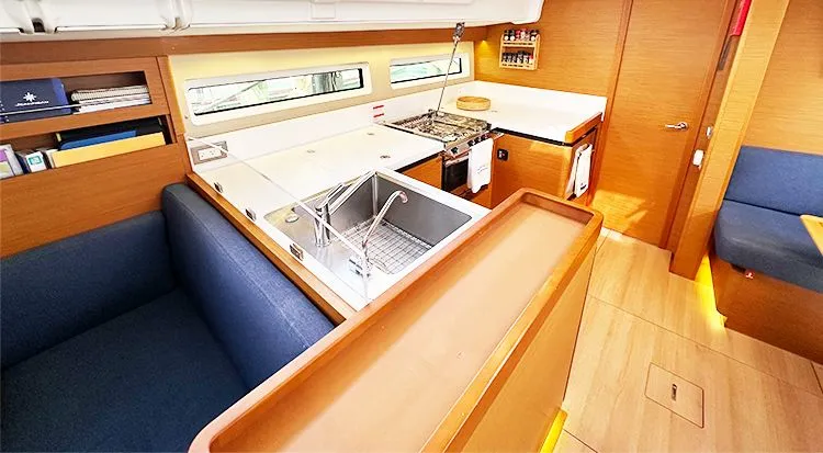 Nautical Dreamer Yacht Photos Pics Interior of 2019 Jeanneau Sun Odyssey 490 yacht, featuring modern kitchen and seating area.