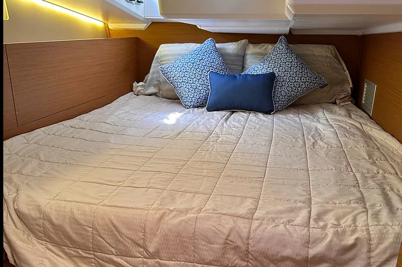 Nautical Dreamer Yacht Photos Pics Cozy cabin bed in 2019 Jeanneau Sun Odyssey 490 yacht with decorative pillows.