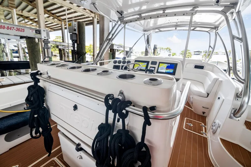 Pura Vita Yacht Photos Pics 2006 Intrepid 377 WA boat interior with helm, seating, and navigation equipment.