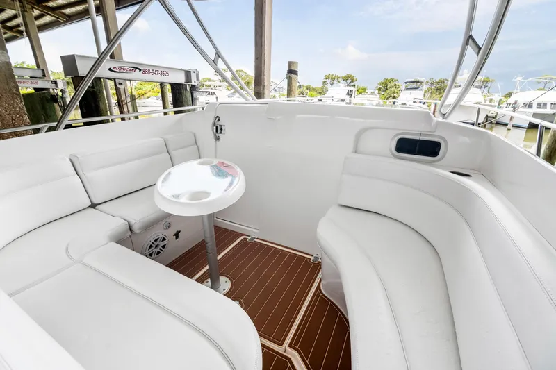 Pura Vita Yacht Photos Pics 2006 Intrepid 377 WA boat interior with white seating and small table, docked at marina.
