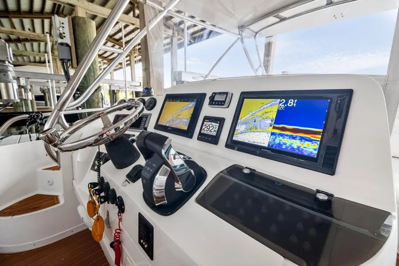 Pura Vita Yacht Photos Pics 2006 Intrepid 377 WA boat dashboard with navigation screens and steering wheel.