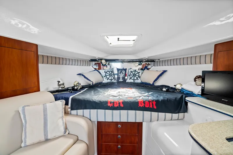 Pura Vita Yacht Photos Pics Interior of a 2006 Intrepid 377 WA boat with cozy bed and nautical decor.