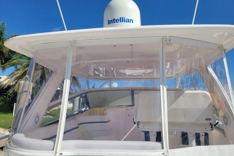 Previous Freshwater !! Yacht Photos Pics 2016 Intrepid 475 Sport Yacht cockpit with clear enclosure and seating, under blue sky.