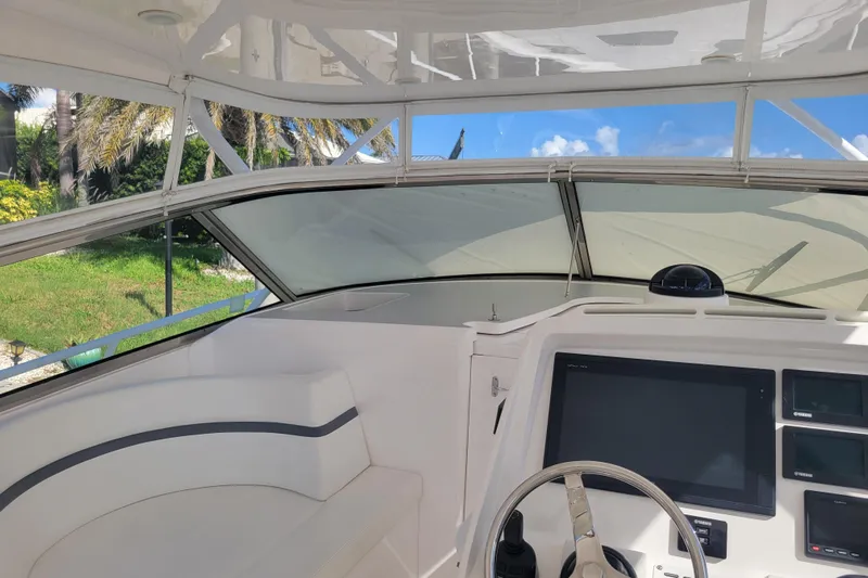 Previous Freshwater !! Yacht Photos Pics Interior view of 2016 Intrepid 475 Sport Yacht cockpit with steering wheel and navigation screens.