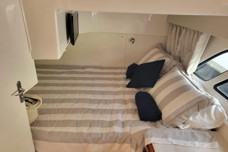 Previous Freshwater !! Yacht Photos Pics Cozy cabin interior of 2016 Intrepid 475 Sport Yacht with striped bedding and pillows.