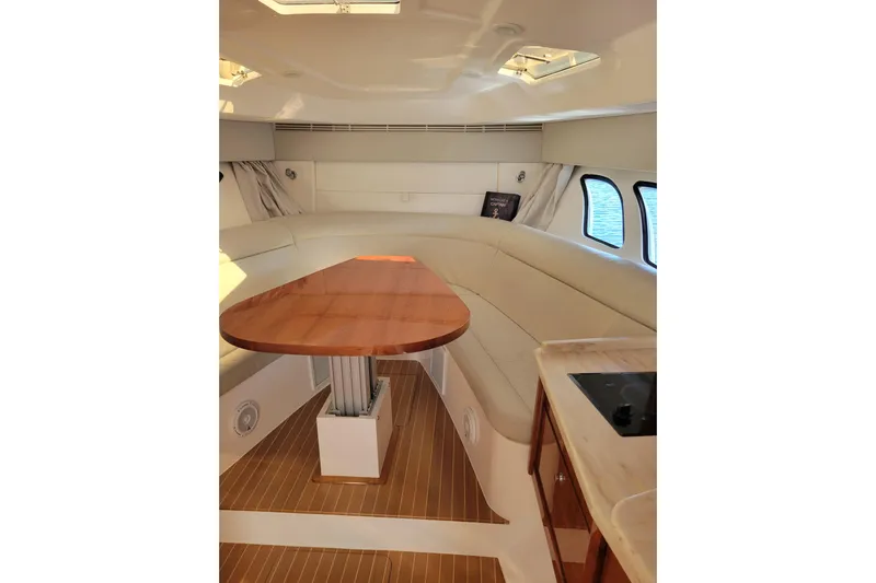 Previous Freshwater !! Yacht Photos Pics Interior of 2016 Intrepid 475 Sport Yacht with elegant seating and wooden table.