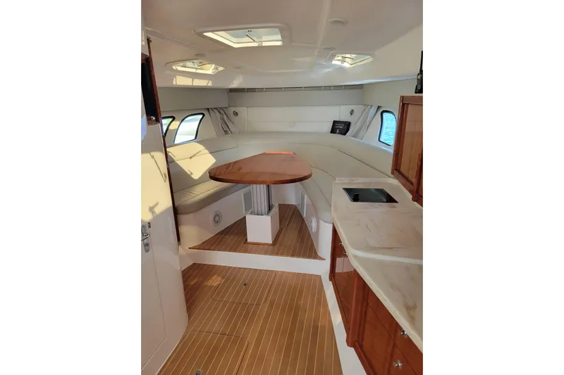 Previous Freshwater !! Yacht Photos Pics Interior of 2016 Intrepid 475 Sport Yacht with elegant seating and wooden finishes.