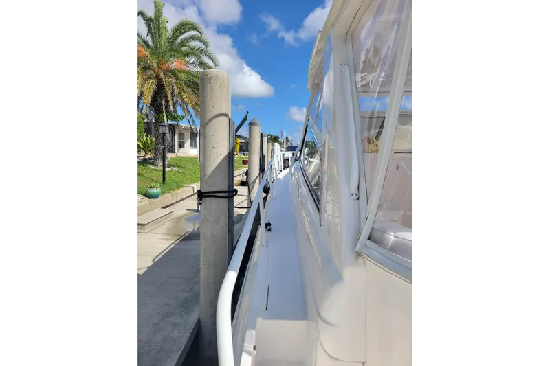 Previous Freshwater !! Yacht Photos Pics 2016 Intrepid 475 Sport Yacht docked, featuring sleek design and clear skies.