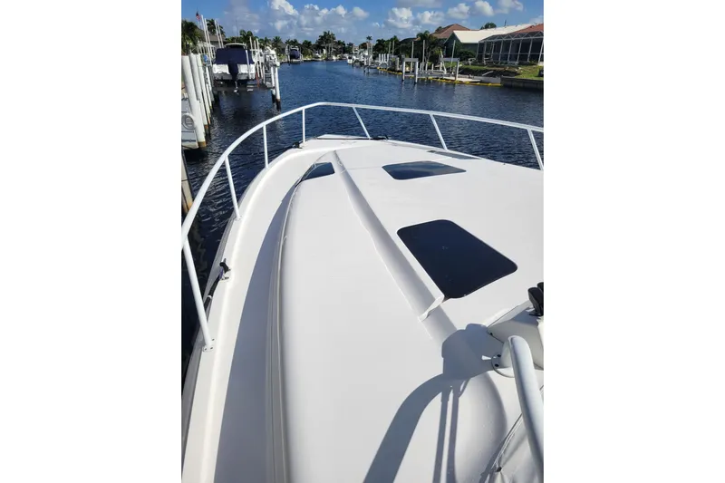 Previous Freshwater !! Yacht Photos Pics 2016 Intrepid 475 Sport Yacht on a sunny marina, showcasing sleek deck design.