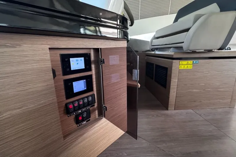  Yacht Photos Pics Control panel inside 2018 Beneteau Gran Turismo 50 Sportfly yacht, featuring modern wood finish.
