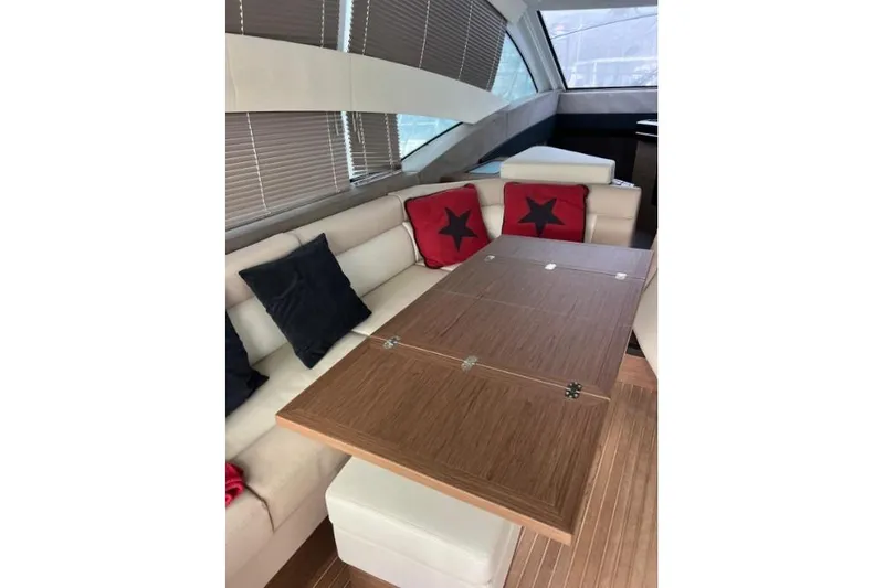  Yacht Photos Pics Interior of 2018 Beneteau Gran Turismo 50 Sportfly with stylish seating and wooden table.