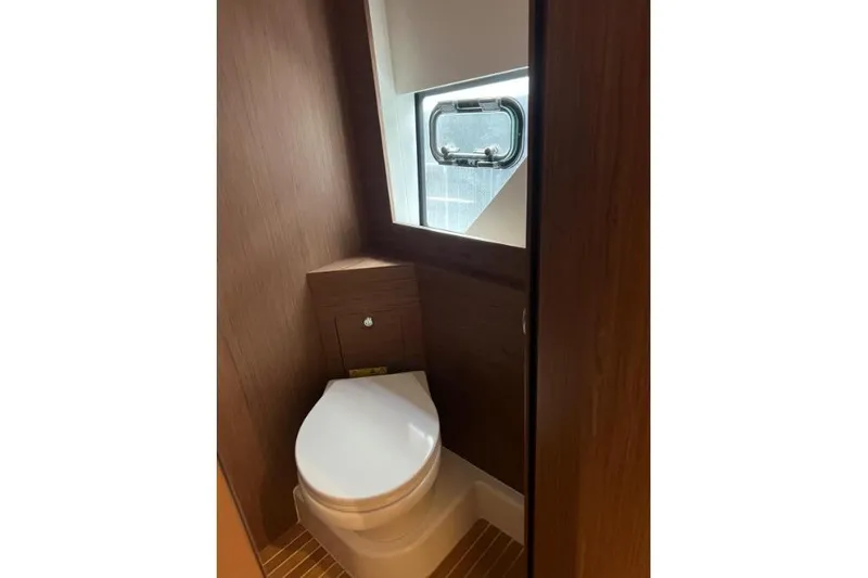  Yacht Photos Pics 2018 Beneteau Gran Turismo 50 Sportfly yacht bathroom with wooden interior and window.