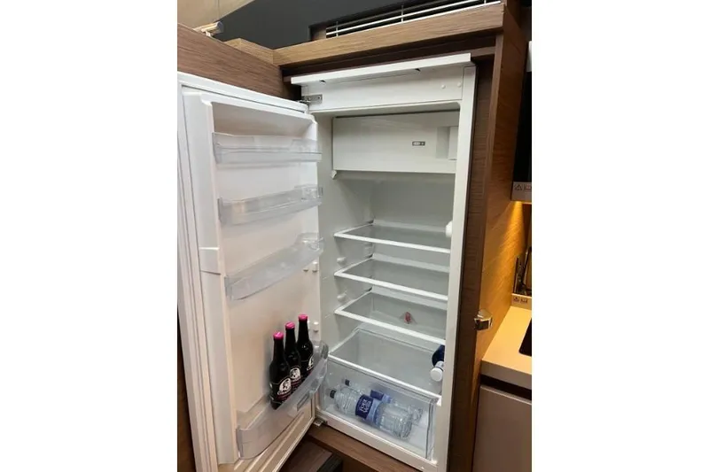  Yacht Photos Pics Open fridge in 2018 Beneteau Gran Turismo 50 Sportfly yacht, partially stocked with drinks.