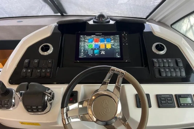  Yacht Photos Pics Control panel of 2018 Beneteau Gran Turismo 50 Sportfly with touchscreen and steering wheel.