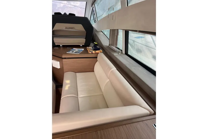  Yacht Photos Pics Interior of 2018 Beneteau Gran Turismo 50 Sportfly with beige seating and wooden accents.