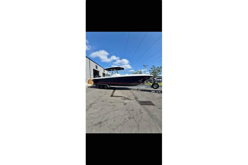 Yacht Photos Pics 2018 Intrepid 32 boat on trailer, parked outdoors under a clear blue sky.