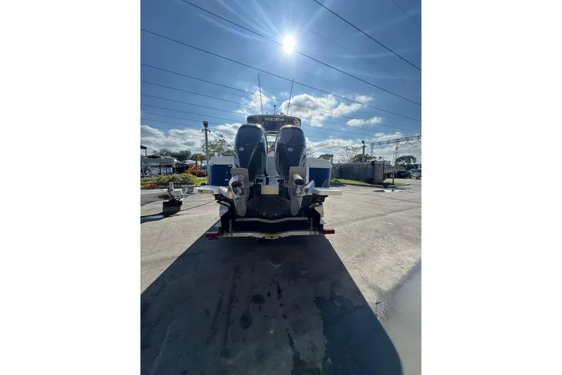  Yacht Photos Pics 2018 Intrepid 32 boat with dual outboard motors in a sunny outdoor setting.