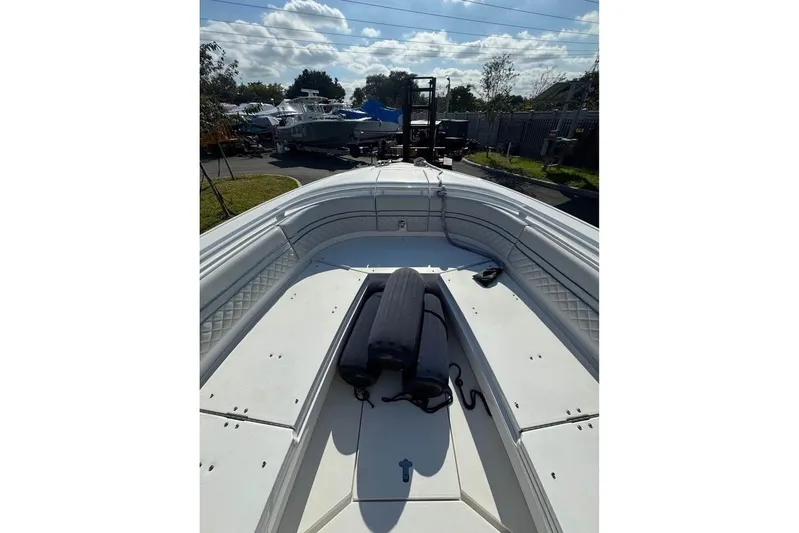 Yacht Photos Pics 2018 Intrepid 32 boat deck with seating and storage, parked outdoors under a cloudy sky.