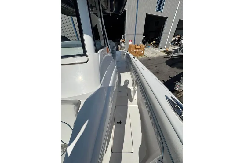  Yacht Photos Pics 2018 Intrepid 32 boat deck view with shadow and storage facility in background.