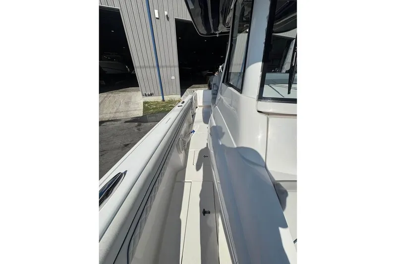  Yacht Photos Pics 2018 Intrepid 32 boat side view, docked near a storage facility.