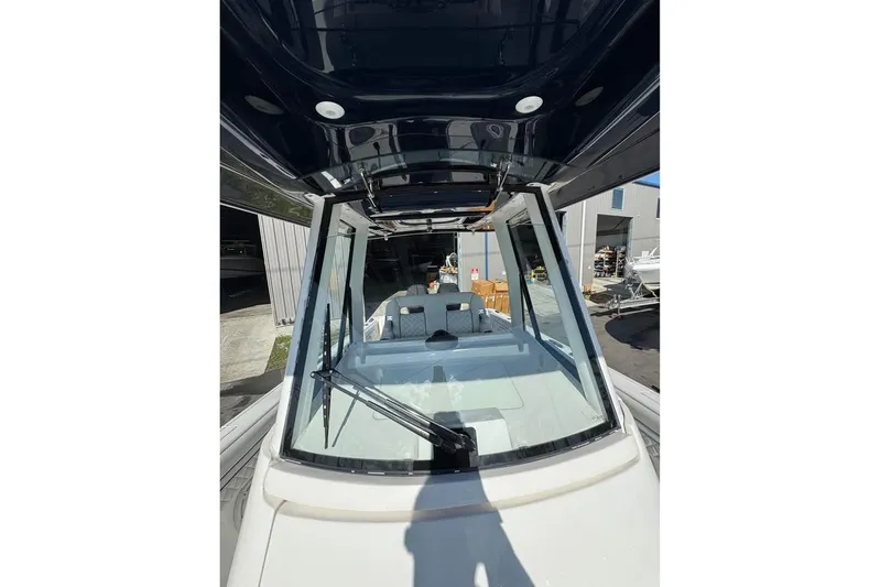  Yacht Photos Pics 2018 Intrepid 32 boat with sleek windshield and modern design in a marina setting.
