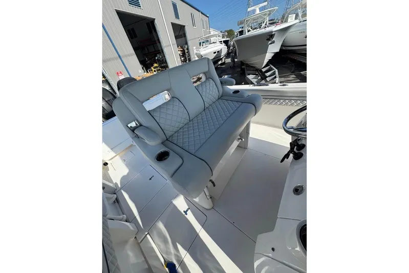  Yacht Photos Pics 2018 Intrepid 32 boat interior with gray quilted seating and cup holder.