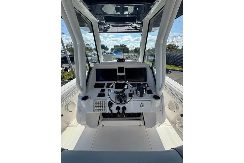  Yacht Photos Pics 2018 Intrepid 32 boat cockpit with steering wheel and control panel.