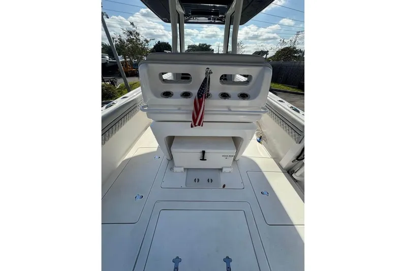  Yacht Photos Pics 2018 Intrepid 32 boat interior with American flag, rod holders, and storage compartments.