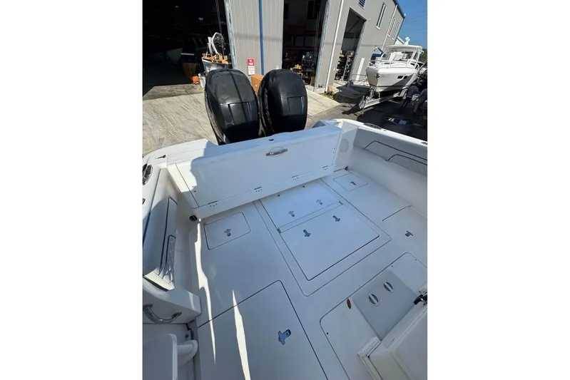  Yacht Photos Pics 2018 Intrepid 32 boat with dual outboard engines, docked near a marina.