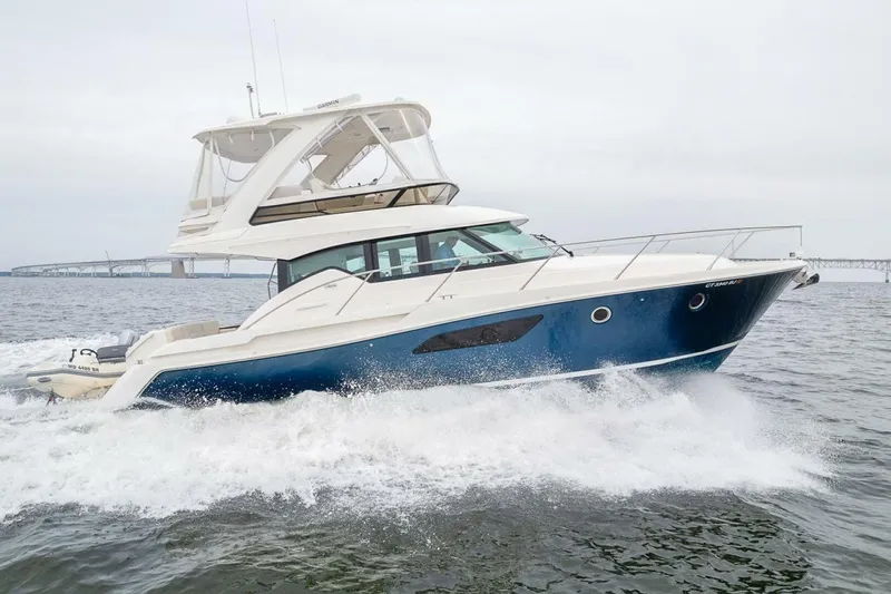  Yacht Photos Pics 2021 Tiara Yachts F44 Flybridge cruising on open water, showcasing sleek design and performance.