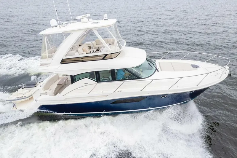  Yacht Photos Pics 2021 Tiara Yachts F44 Flybridge cruising on open water, showcasing sleek design and luxury.