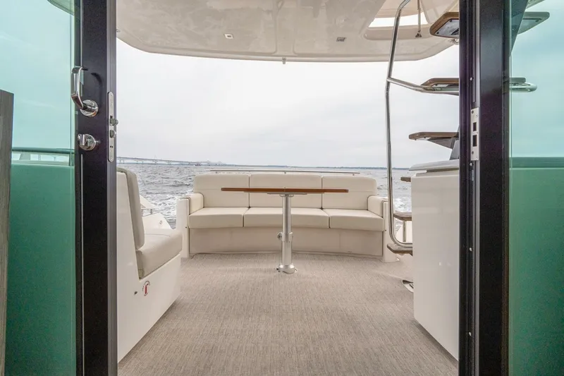  Yacht Photos Pics 2021 Tiara Yachts F44 Flybridge interior with seating and ocean view.