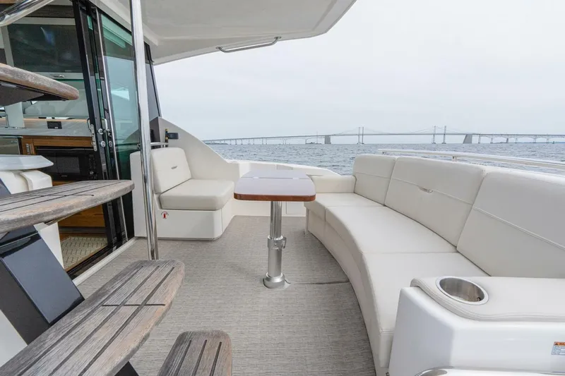  Yacht Photos Pics 2021 Tiara Yachts F44 Flybridge with elegant seating and ocean view.