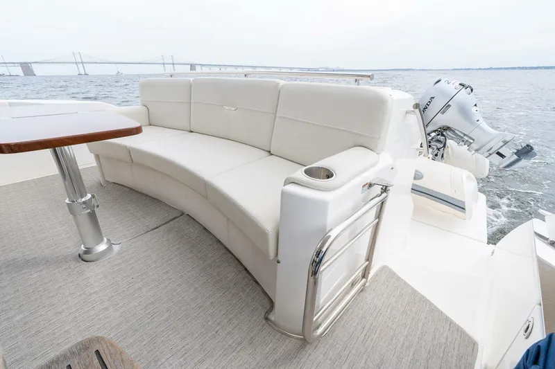  Yacht Photos Pics Luxurious seating area on 2021 Tiara Yachts F44 Flybridge with scenic ocean view.