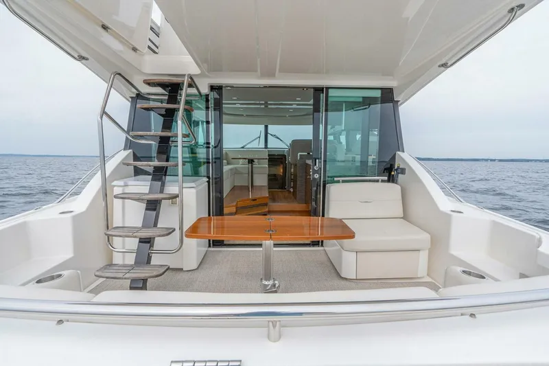  Yacht Photos Pics 2021 Tiara Yachts F44 Flybridge, elegant deck view with seating and ocean backdrop.