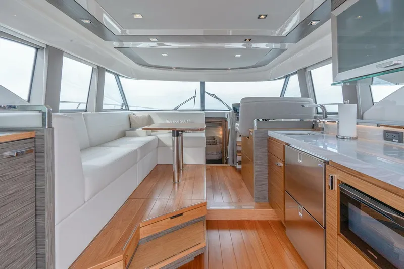  Yacht Photos Pics Luxurious interior of 2021 Tiara Yachts F44 Flybridge with modern kitchen and seating area.