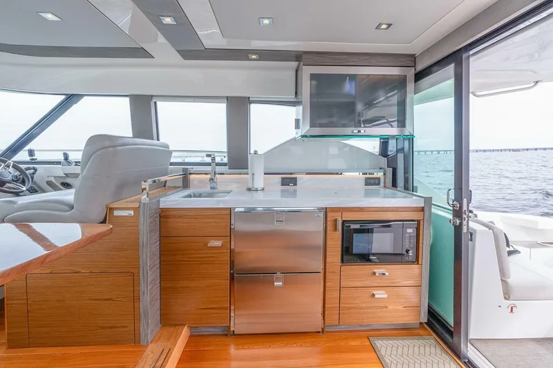  Yacht Photos Pics Luxurious 2021 Tiara Yachts F44 Flybridge interior with modern kitchen and ocean view.